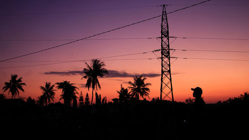 Silhouette man standing against sky during sunset