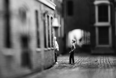 Side view of woman walking against building