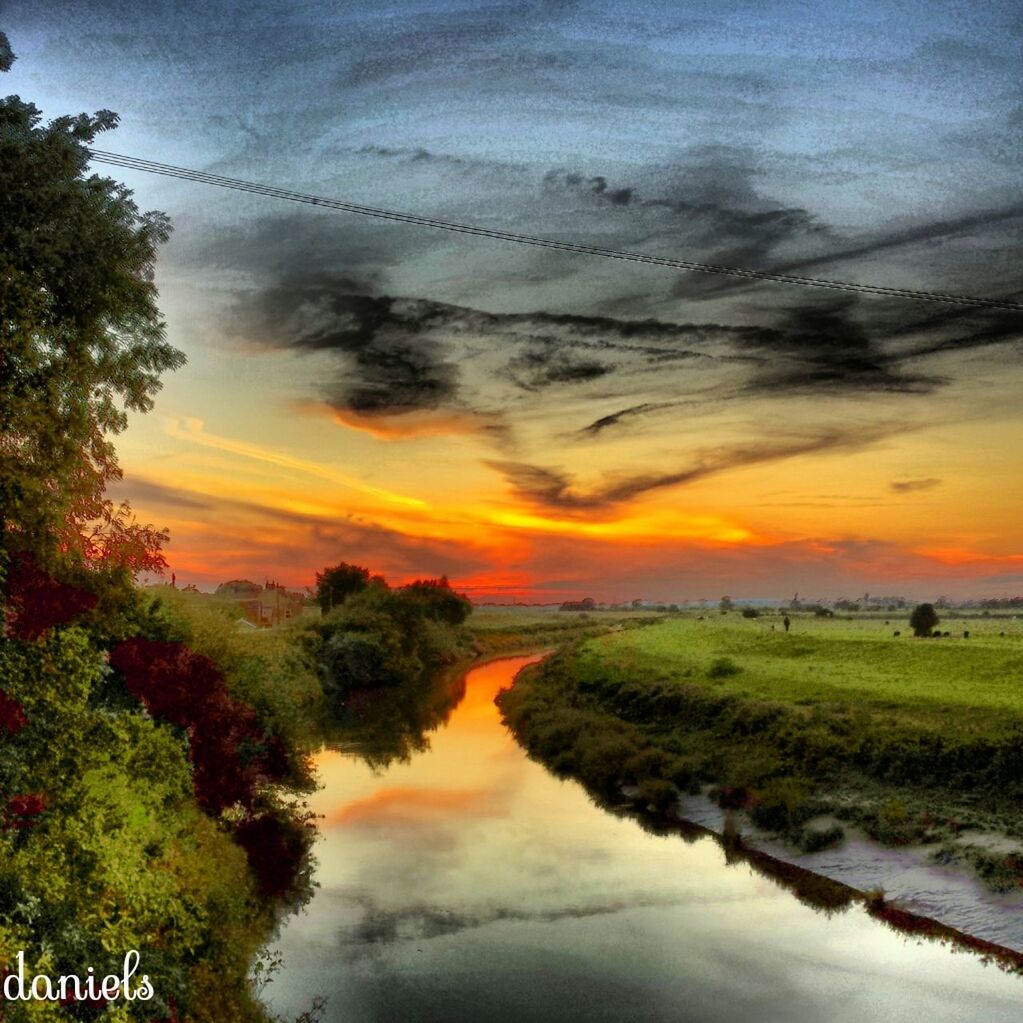 sunset, tranquil scene, tranquility, scenics, water, beauty in nature, tree, sky, reflection, orange color, nature, idyllic, cloud - sky, lake, landscape, cloud, river, dramatic sky, waterfront, non-urban scene