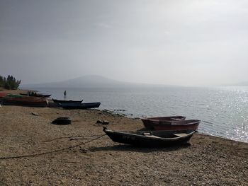 Boats moored on sea against sky