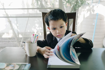 Portrait of boy holding table