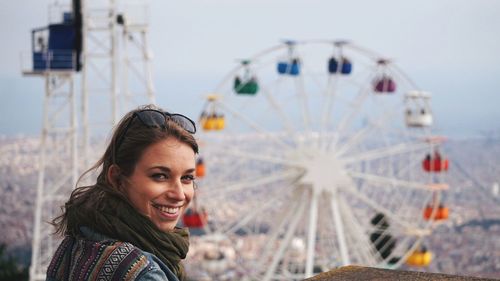 Close-up portrait of a young woman at amusement park