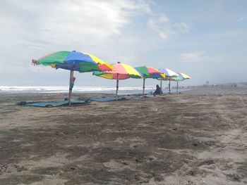 Umbrella on beach against sky