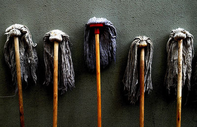 Close-up of mops standing on wall