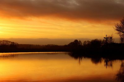 Scenic view of lake against sky during sunset