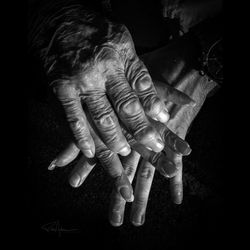 Close-up of woman hand against black background