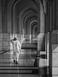 Full length rear view of man visiting mosque