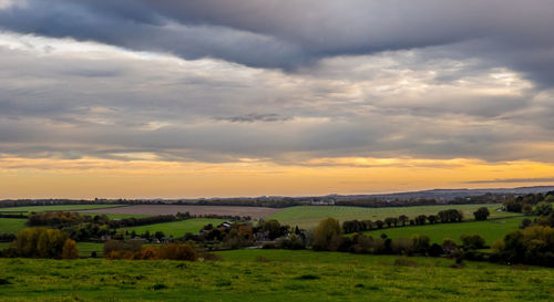 Scenic view of field against sky during sunset