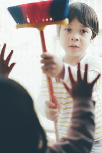 Portrait of cute boy holding camera