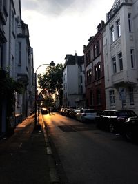 Cars on road along buildings