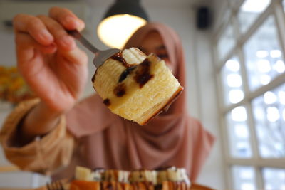 Cropped hand of person holding food