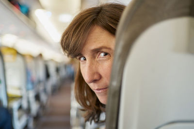 Mature woman on airplane seat