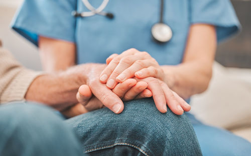 Low section of doctor examining patient