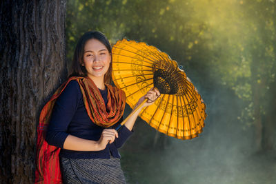 Portrait of a smiling young woman standing outdoors