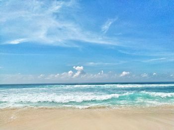 Scenic view of beach against blue sky