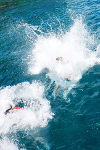 High angle view of waves splashing in sea