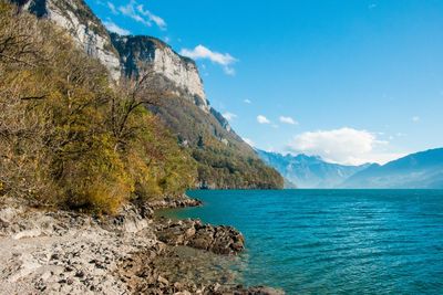 Scenic view of sea and mountains against sky