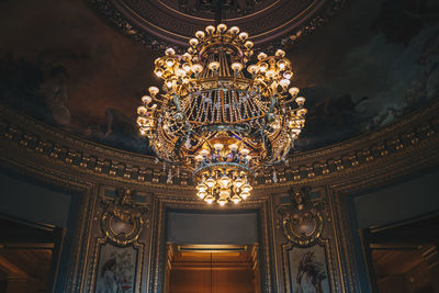 Low angle view of illuminated chandelier in building