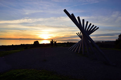 Scenic view of silhouette field against sky during sunset