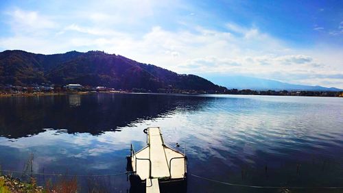 Scenic view of lake against cloudy sky
