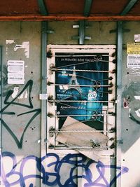 Graffiti on glass door of abandoned building