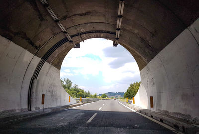 Empty road against sky in city