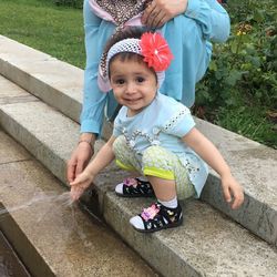 Portrait of cute girl sitting on steps