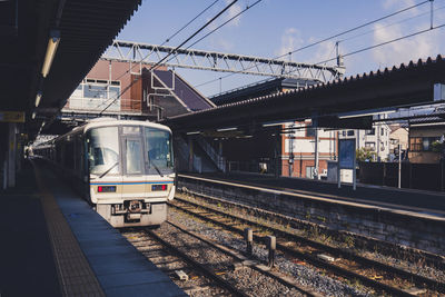 Train at railroad station against sky