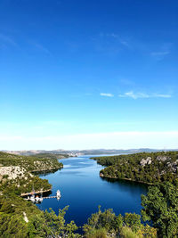 Scenic view of lake against blue sky