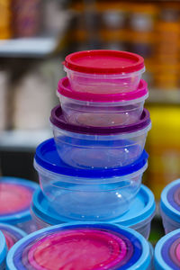 Close-up of multi colored containers for sale