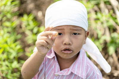 Portrait of boy standing on field