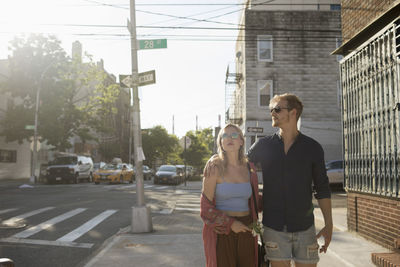 Young couple walking along a street together