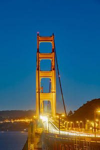 Illuminated bridge over river