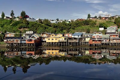 Reflection of buildings and trees in river