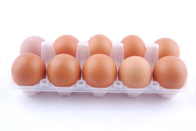 Close-up of eggs against white background