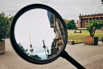 Reflection of buildings on mirror against sky