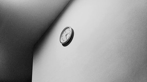 Low angle view of clock on wall