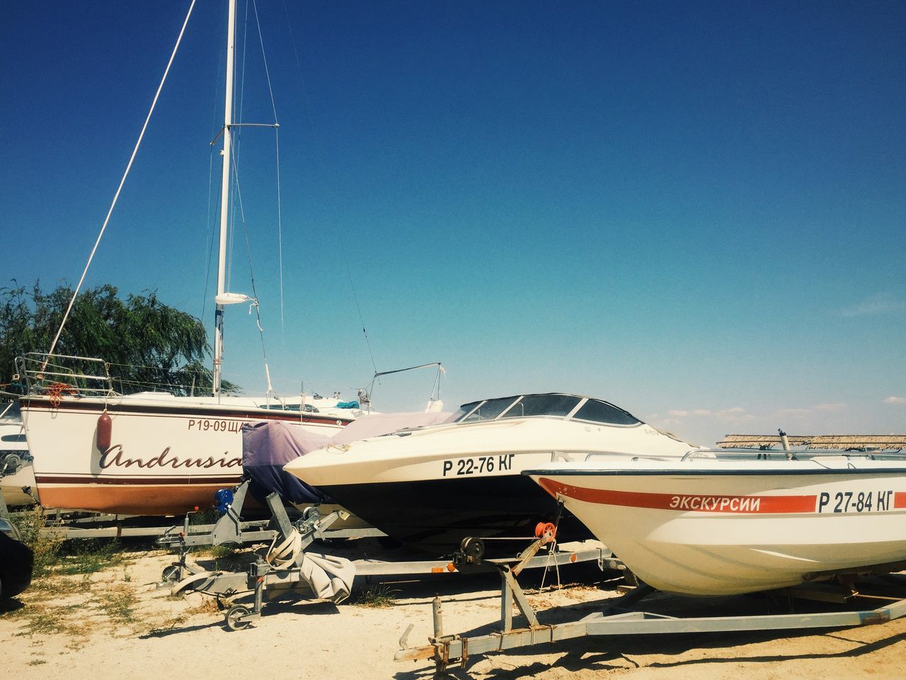 clear sky, transportation, copy space, mode of transport, blue, built structure, architecture, nautical vessel, travel, building exterior, outdoors, boat, sunlight, day, no people, air vehicle, sky, land vehicle, journey, cropped