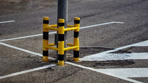 High angle view of yellow road sign bumper  on street