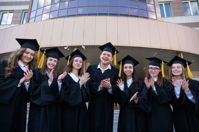 Portrait of smiling young woman wearing graduation gown