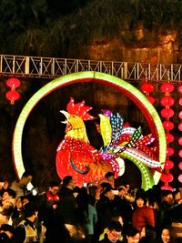 Close-up of illuminated horse on tree at night