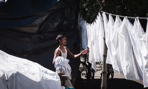 Man drying clothes outdoors