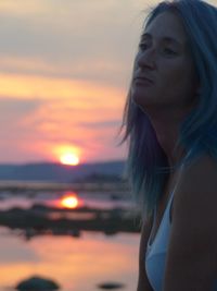 Beautiful woman at beach during sunset