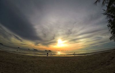 Scenic view of beach against sky during sunset