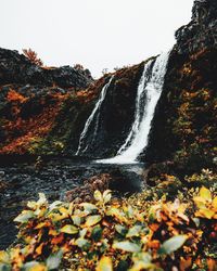 Scenic view of waterfall against sky