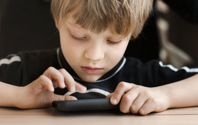 Boy playing on cell phone, sweden