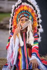 Portrait of woman with multi colored umbrella