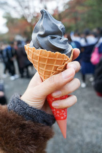 Close-up of hand holding ice cream