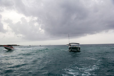 Ship sailing on sea against sky