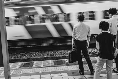 Rear view of people at railroad station